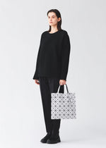 A model wears the BAO BAO ISSEY MIYAKE LUCENT MATTE tote bag.