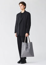 A model wears the BAO BAO ISSEY MIYAKE TRACK tote bag.