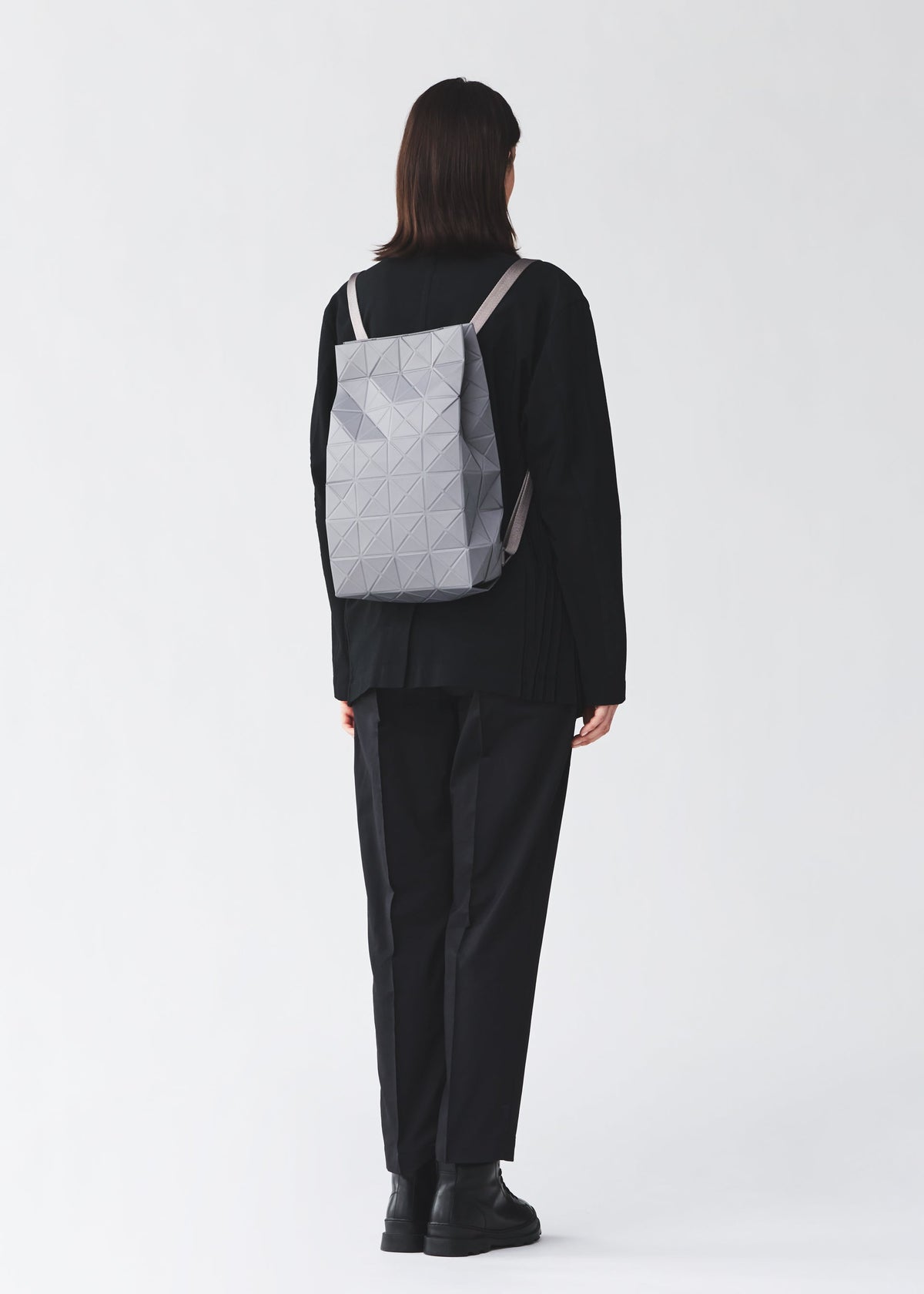 A model wears the BAO BAO ISSEY MIYAKE TRACK backpack.