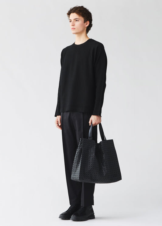 A model wears the BAO BAO ISSEY MIYAKE CART cart-tote-bag-matte-black.