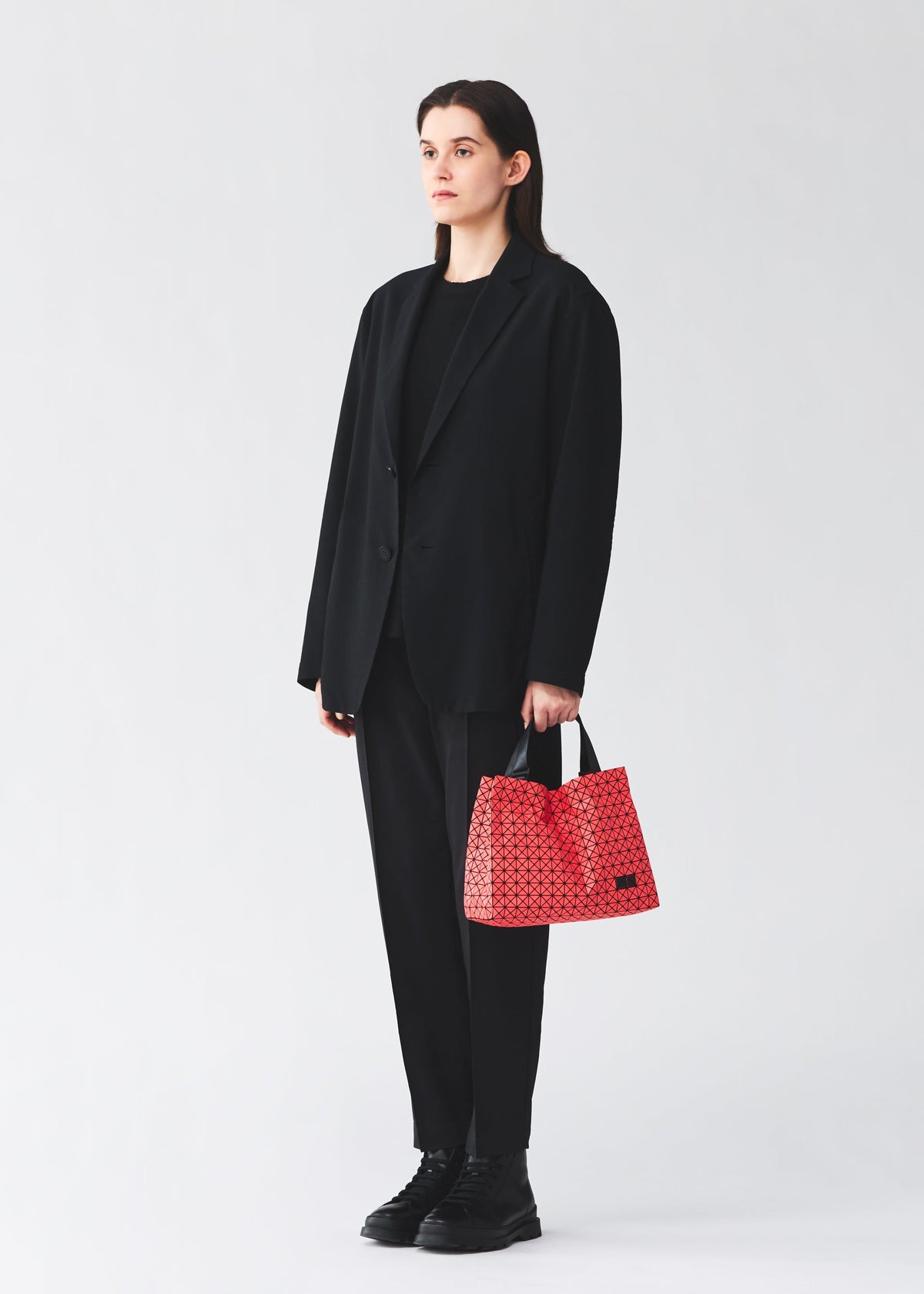 A model wears the BAO BAO ISSEY MIYAKE CART MINI tote bag.