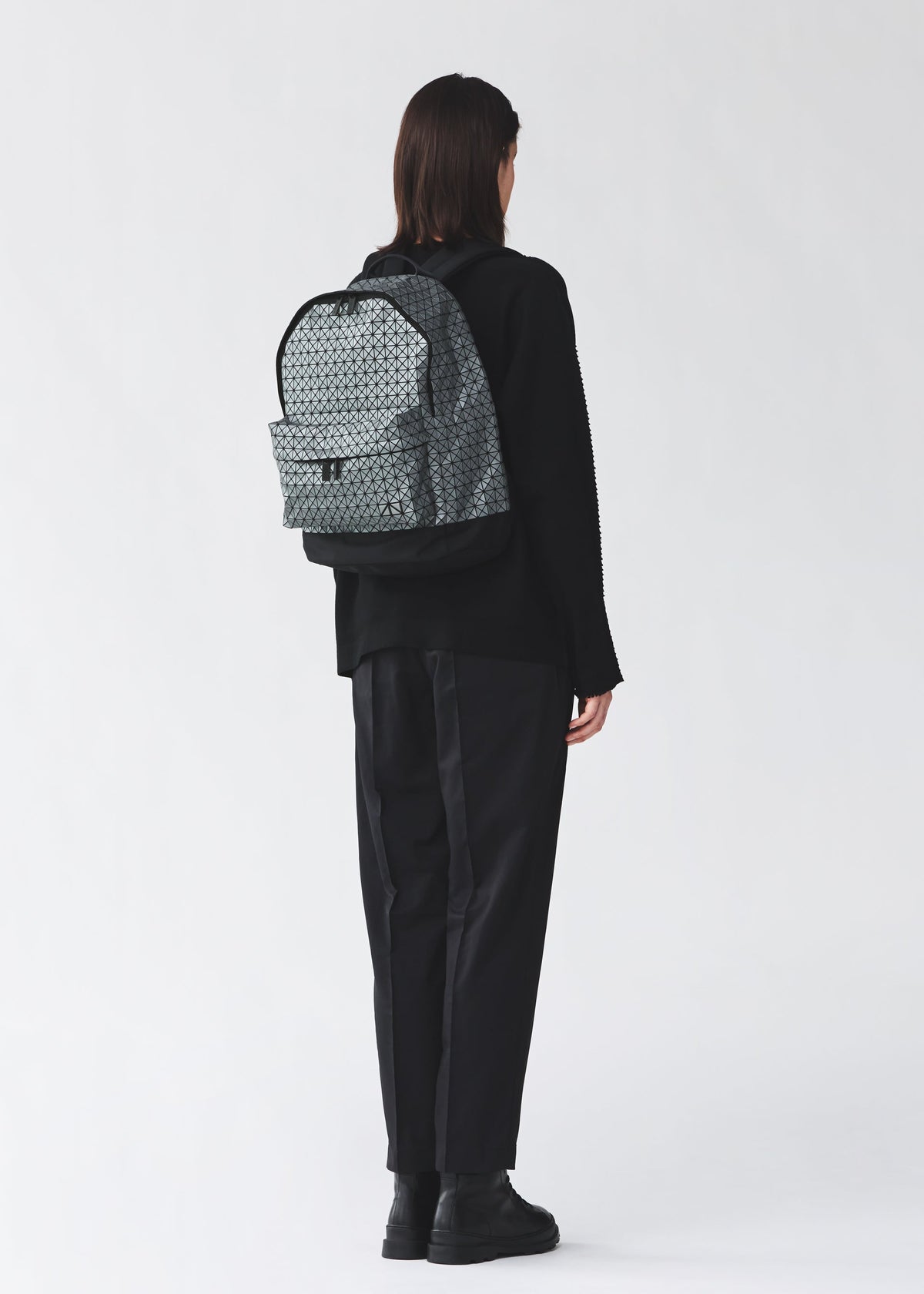 A model wears the BAO BAO ISSEY MIYAKE DAYPACK REFLECTOR daypack-reflector-backpack-1.