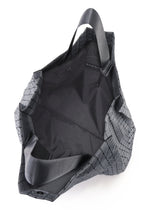 A detail shot of the BAO BAO ISSEY MIYAKE CART REFLECTOR tote bag.