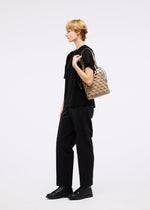 A model wears the GOOD GOODS ISSEY MIYAKE AMIME bag.