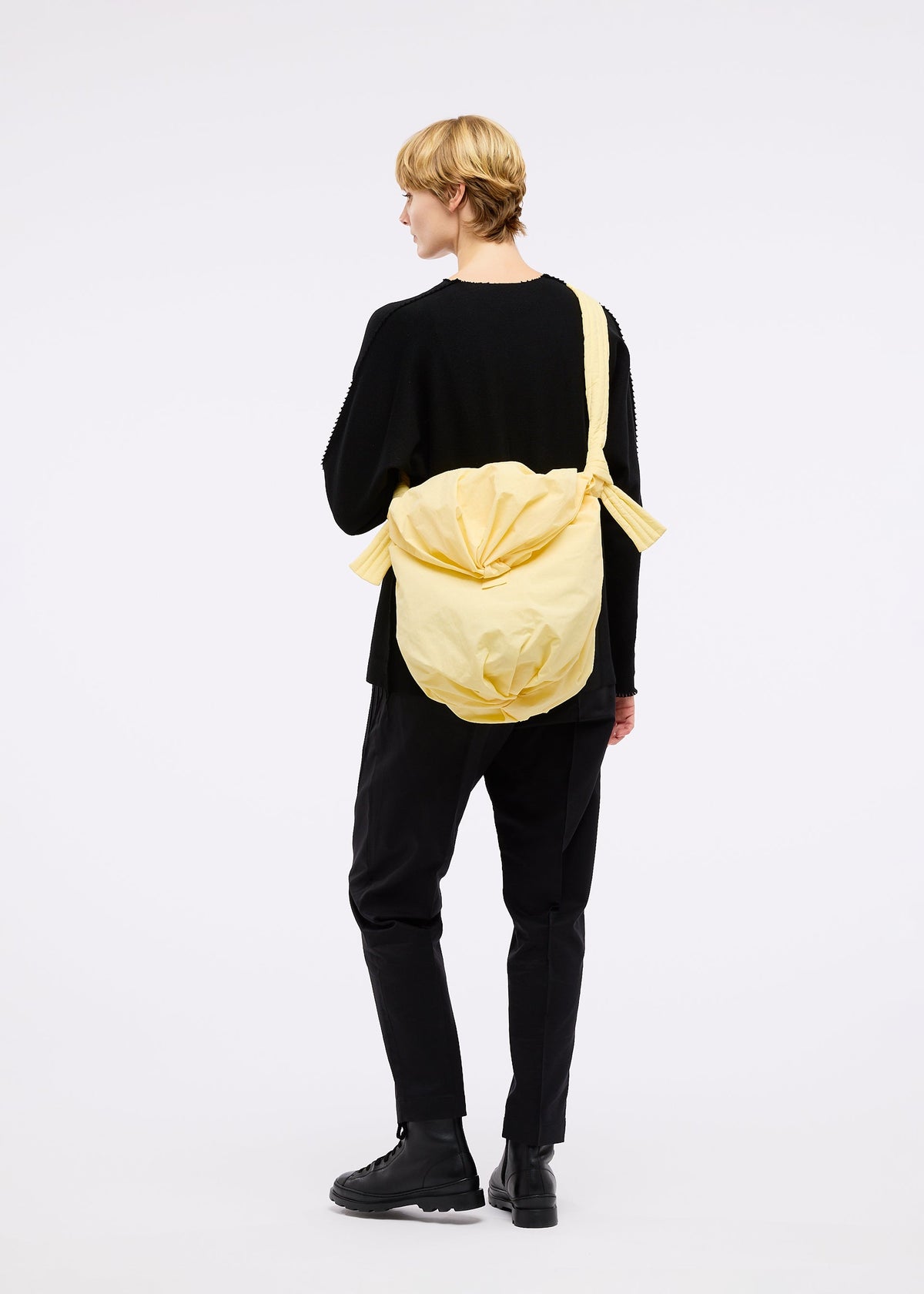 A model wears the Good Goods Issey Miyake FUWA FUWA bag.