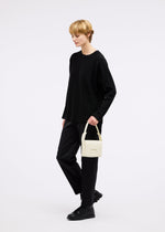 A model wears the GOOD GOODS ISSEY MIYAKE BOX bag.