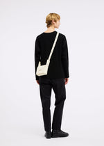 A model wears the GOOD GOODS ISSEY MIYAKE BOX bag.