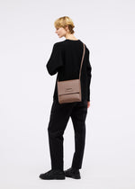 A model wears the GOOD GOODS ISSEY MIYAKE BOX bag.