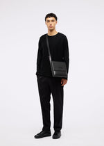 A model wears the GOOD GOODS ISSEY MIYAKE BOX bag.