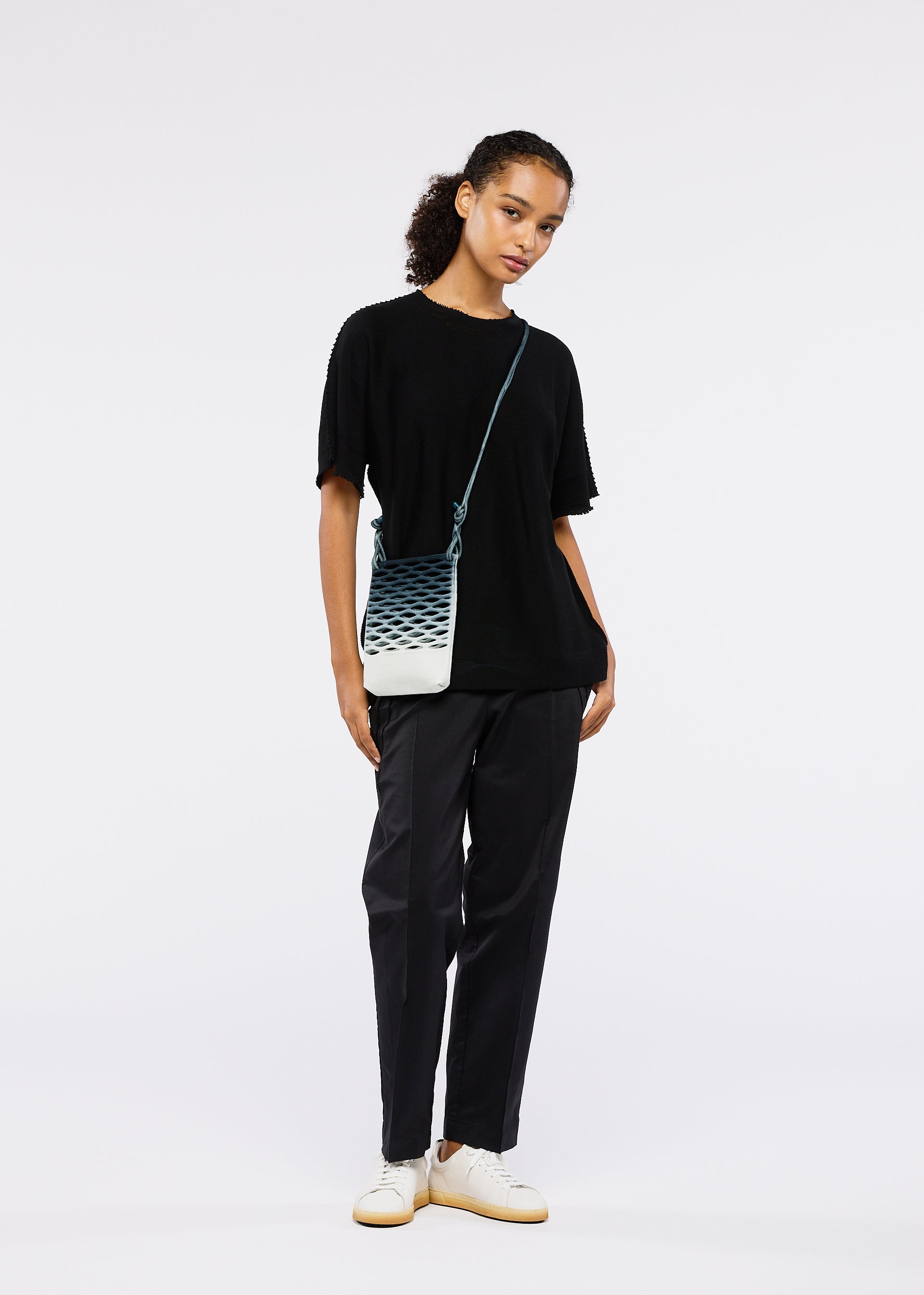 A model wears the GOOD GOODS ISSEY MIYAKE MOKKO NET GRADATION gg66ag37174os.