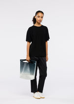 A model wears the GOOD GOODS ISSEY MIYAKE MOKKO NET GRADATION gg66ag37374os.