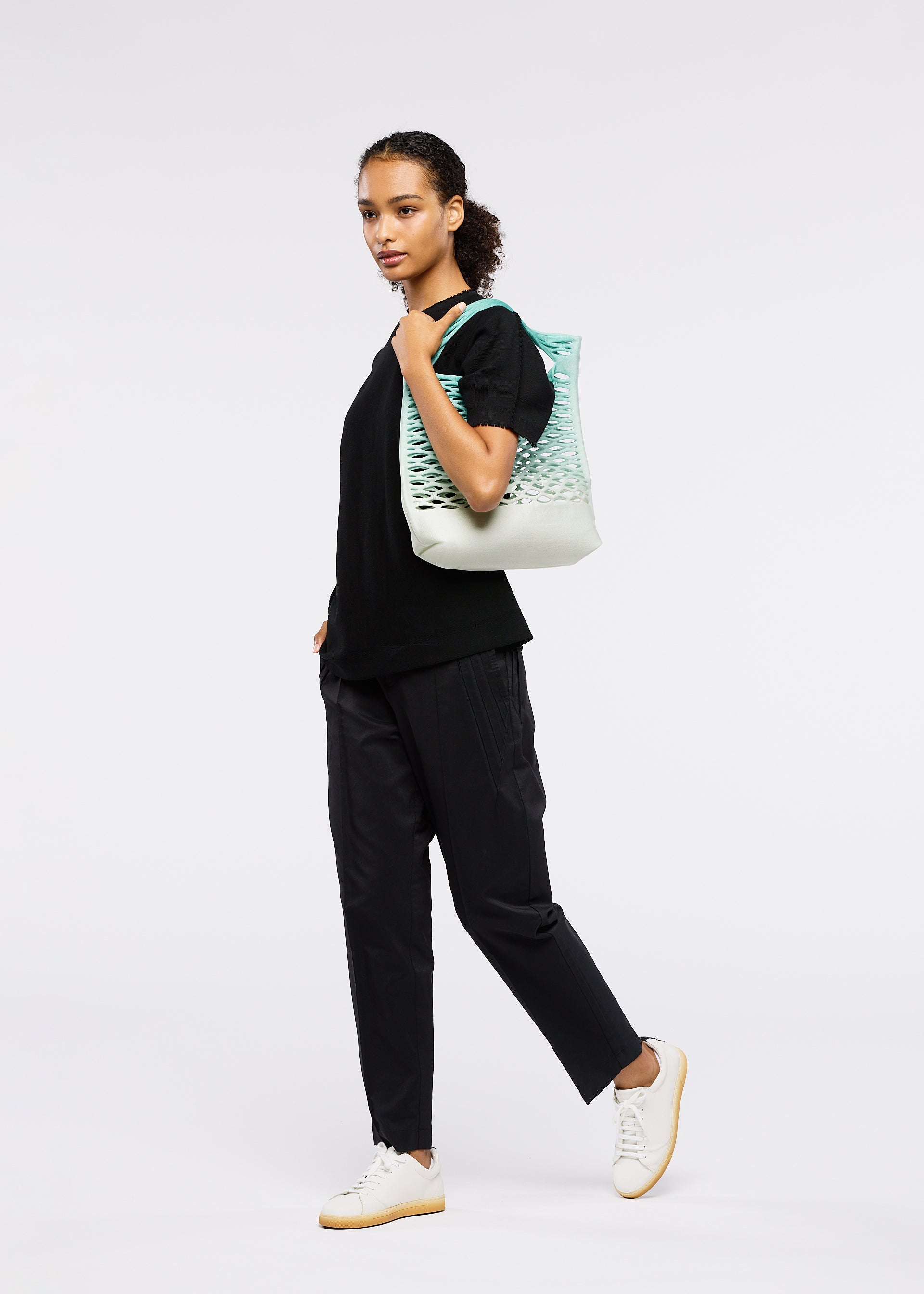 A model wears the GOOD GOODS ISSEY MIYAKE MOKKO NET GRADATION gg66ag37374os.