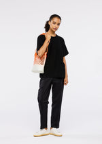 A model wears the GOOD GOODS ISSEY MIYAKE MOKKO NET GRADATION gg66ag37474os.