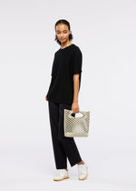 A model wears the Good Goods Issey Miyake MOKKO BASKET .