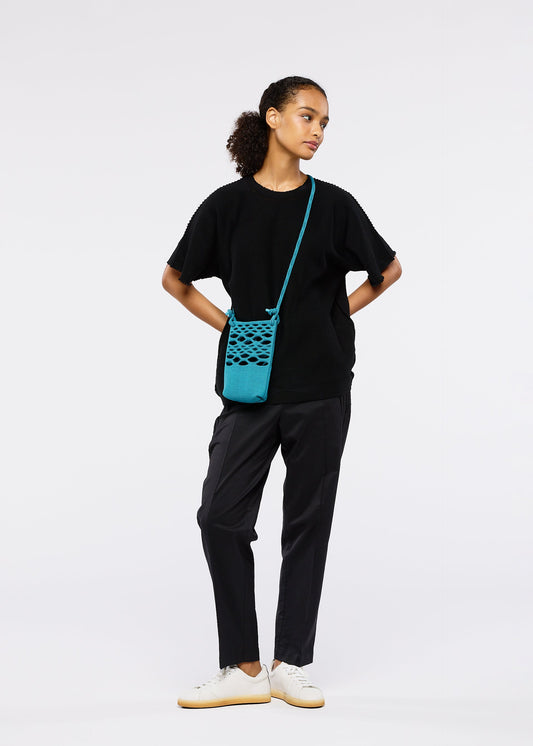 A model wears the Good Goods Issey Miyake MOKKO BASKET .
