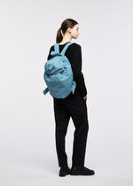 A model wears the GOOD GOODS ISSEY MIYAKE FUWA FUWA fuwa-fuwa-beige.