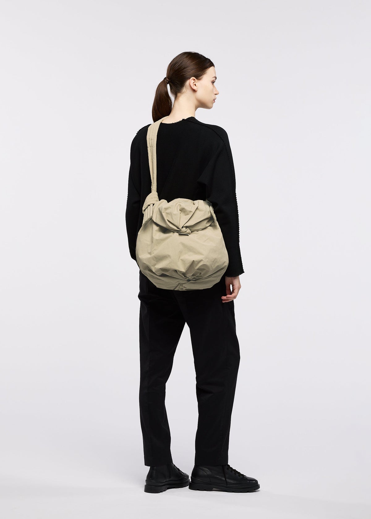 A model wears the GOOD GOODS ISSEY MIYAKE FUWA FUWA fuwa-fuwa-beige-1.