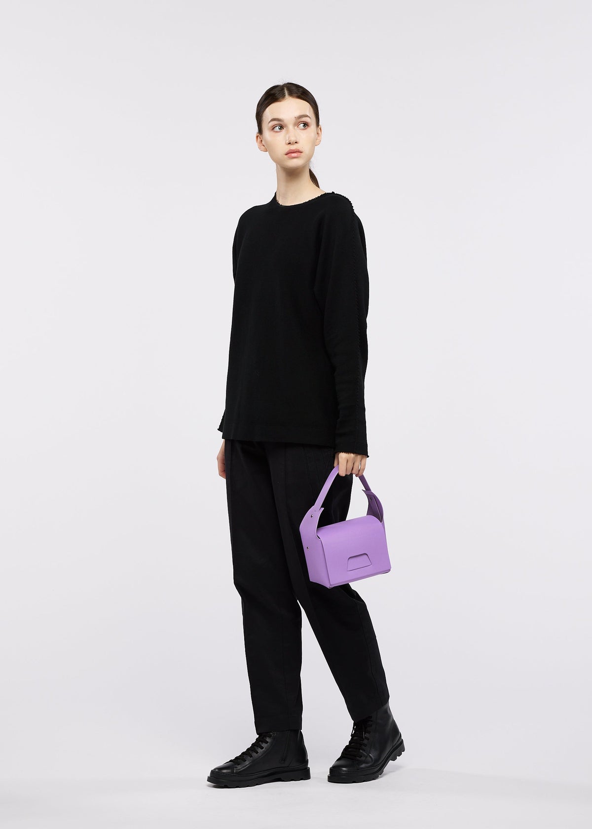 A model wears the GOOD GOODS ISSEY MIYAKE BOX bag.