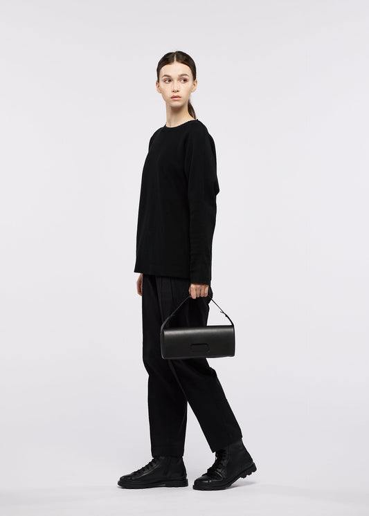 A model wears the GOOD GOODS ISSEY MIYAKE BOX bag.