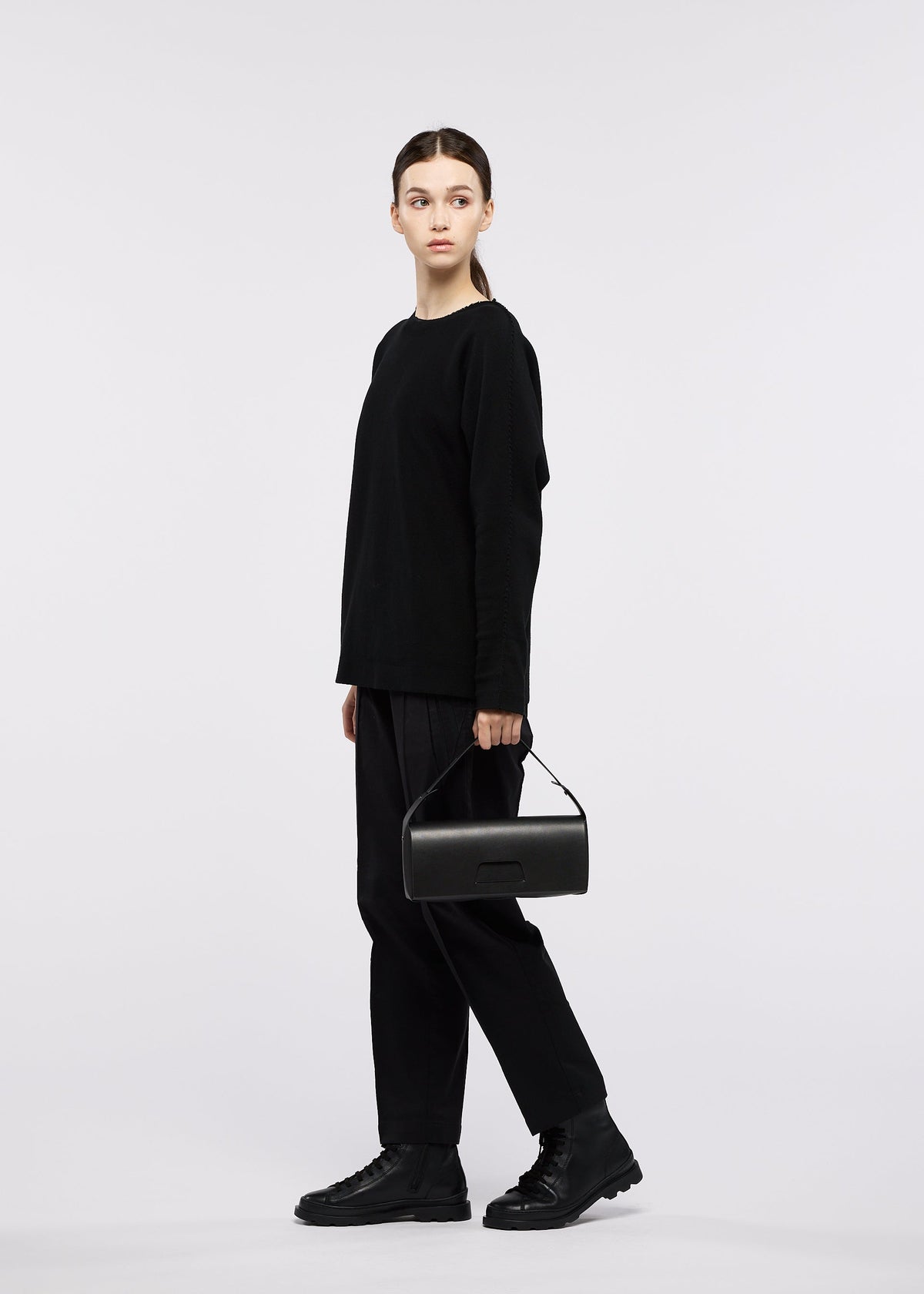 A model wears the GOOD GOODS ISSEY MIYAKE BOX bag.