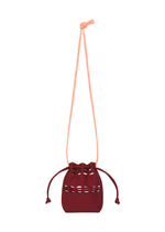 A product shot of the GOOD GOODS ISSEY MIYAKE MOKKO POCKET BI-COLOR bag in bordeaux.