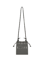 A detail shot of the GOOD GOODS ISSEY MIYAKE MOKKO POCKET BI-COLOR bag.