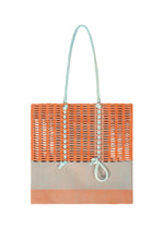 A product shot of the GOOD GOODS ISSEY MIYAKE MOKKO KNOT bag in warm orange mix.