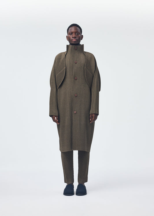 A model wears the Homme Plisse Issey Miyake WOOL LIKE LIGHT coat.