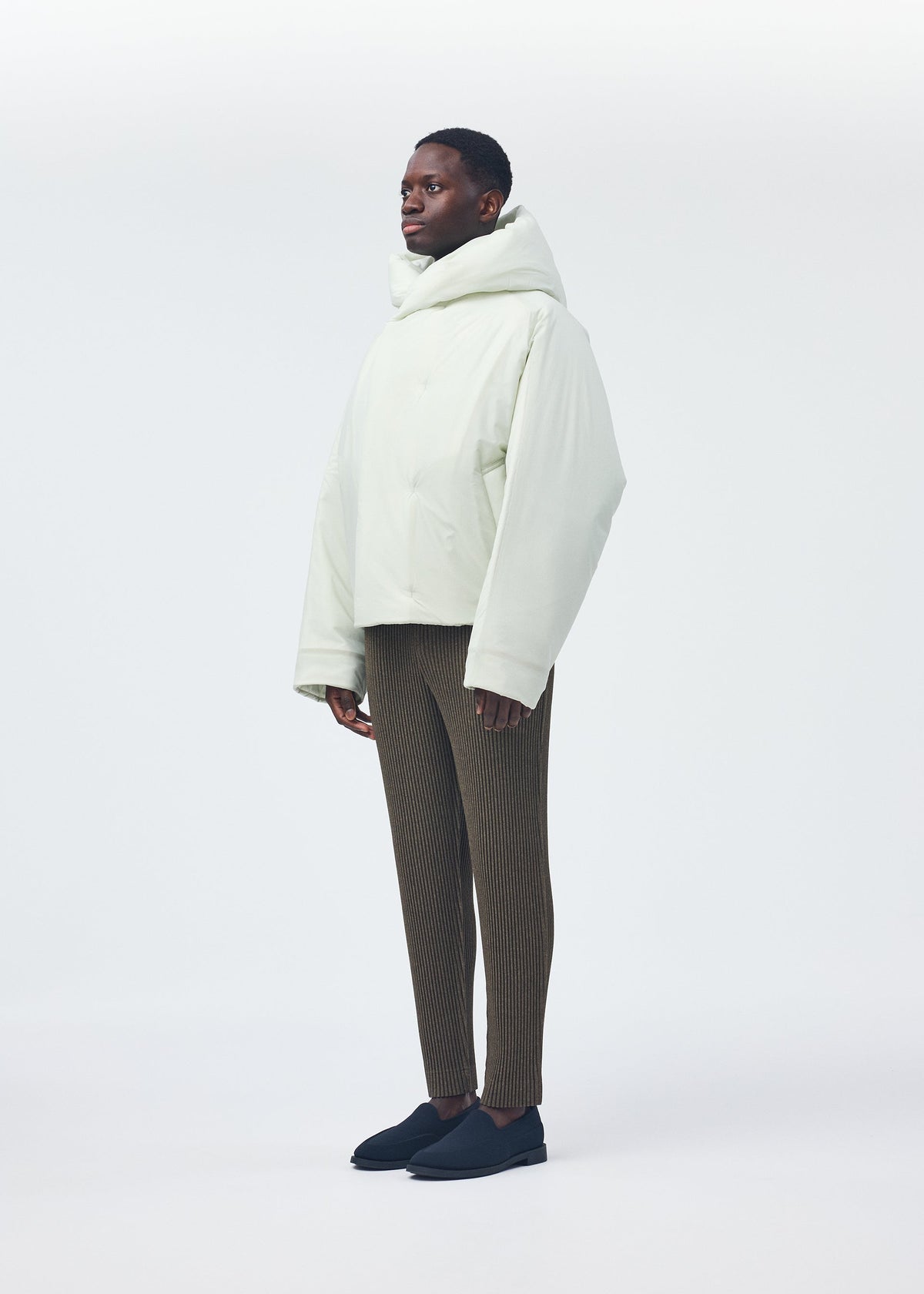 A model wears the Homme Plisse Issey Miyake DUVET COAT blouson.