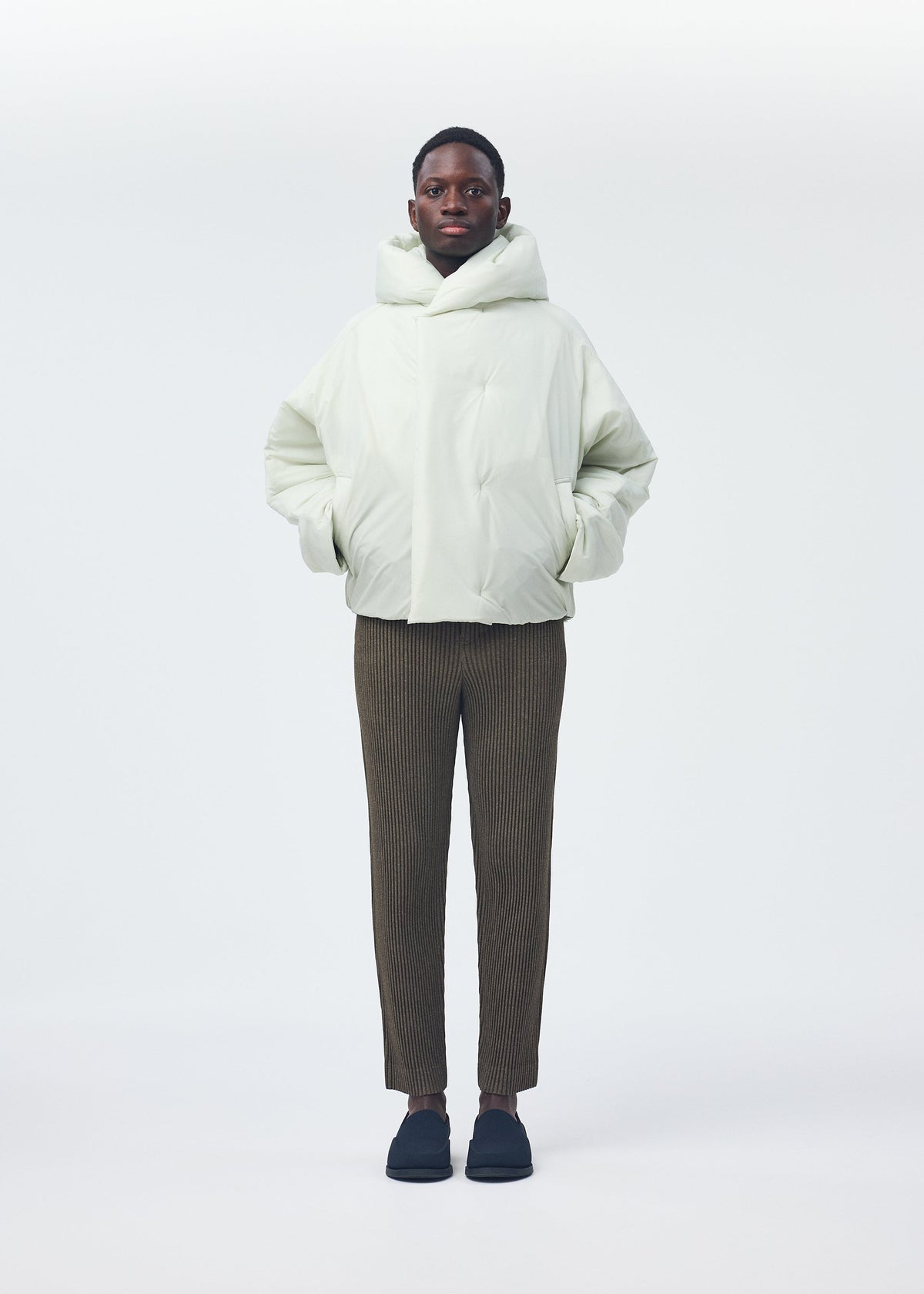 A model wears the Homme Plisse Issey Miyake DUVET COAT blouson.