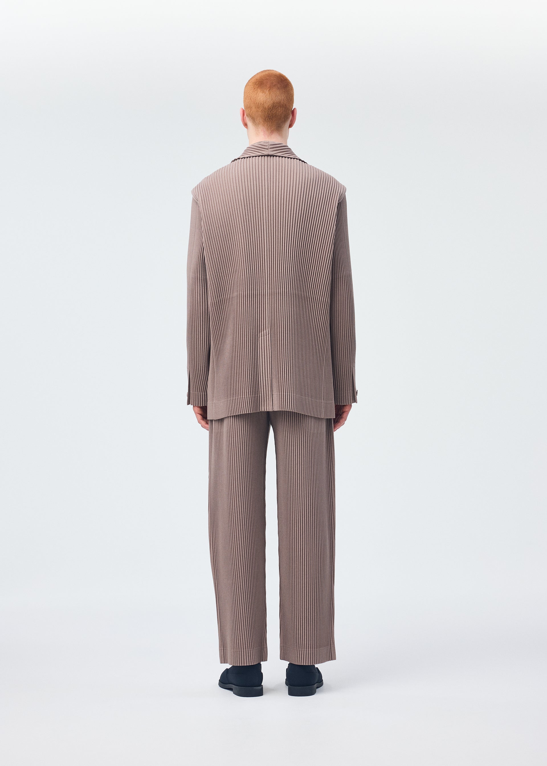 A model wears the Homme Plisse Issey Miyake KERSEY PLEATS jacket.