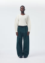 A model wears the Homme Plisse Issey Miyake QUARRY Trousers trousers.
