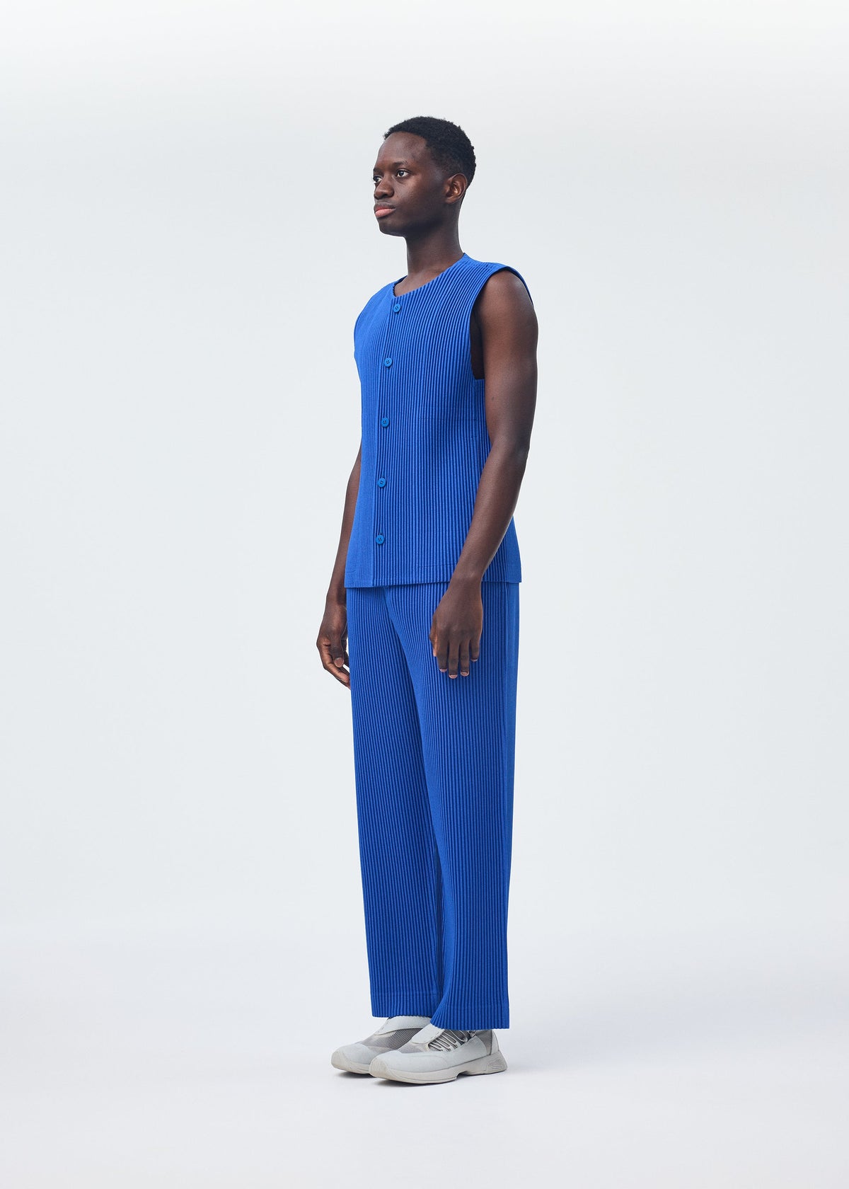A model wears the Homme Plisse Issey Miyake KERSEY PLEATS trousers.