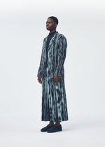 A model wears the HOMME PLISSÉ ISSEY MIYAKE BRUSHSTROKE STRIPE trousers.