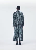 A model wears the HOMME PLISSÉ ISSEY MIYAKE BRUSHSTROKE STRIPE trousers.