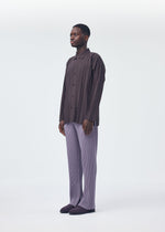 A model wears the HOMME PLISSÉ ISSEY MIYAKE EDGE SHIRT shirt.