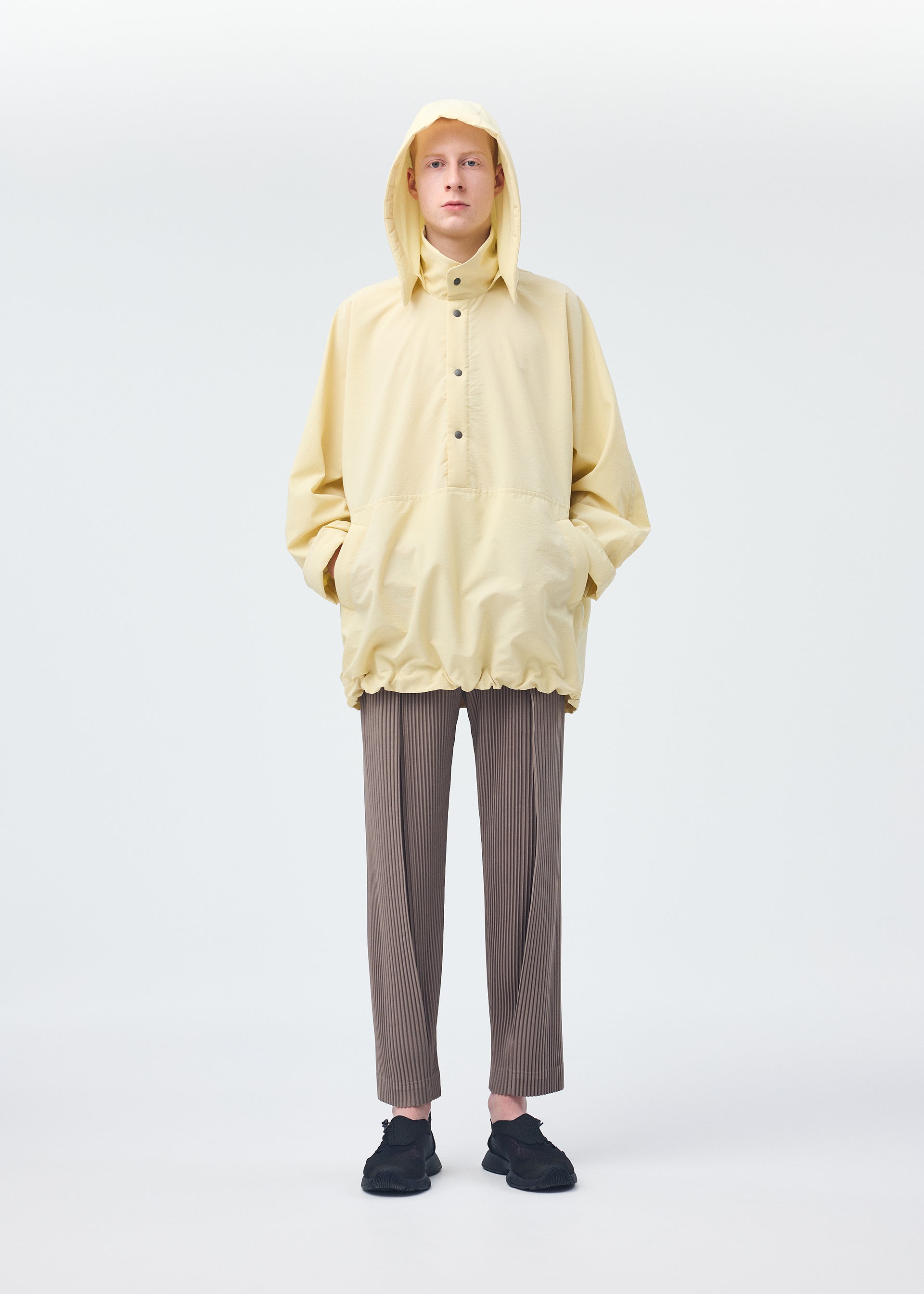 A model wears the Homme Plisse Issey Miyake PADDED RIM SHIRT shirt.