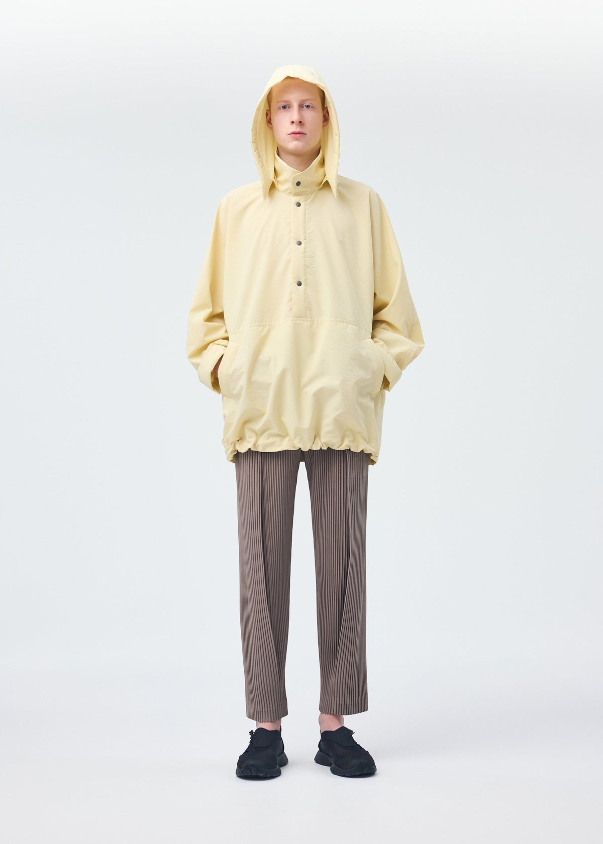 A model wears the Homme Plisse Issey Miyake PADDED RIM SHIRT shirt.