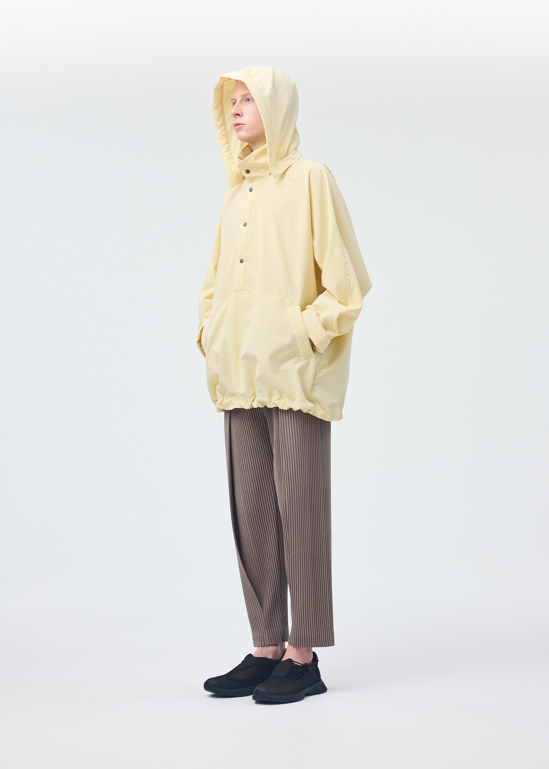 A model wears the Homme Plisse Issey Miyake PADDED RIM SHIRT shirt.