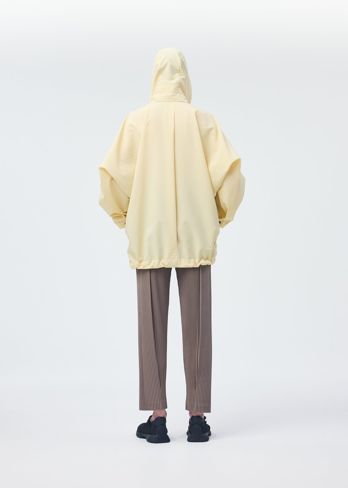 A model wears the Homme Plisse Issey Miyake PADDED RIM SHIRT shirt.