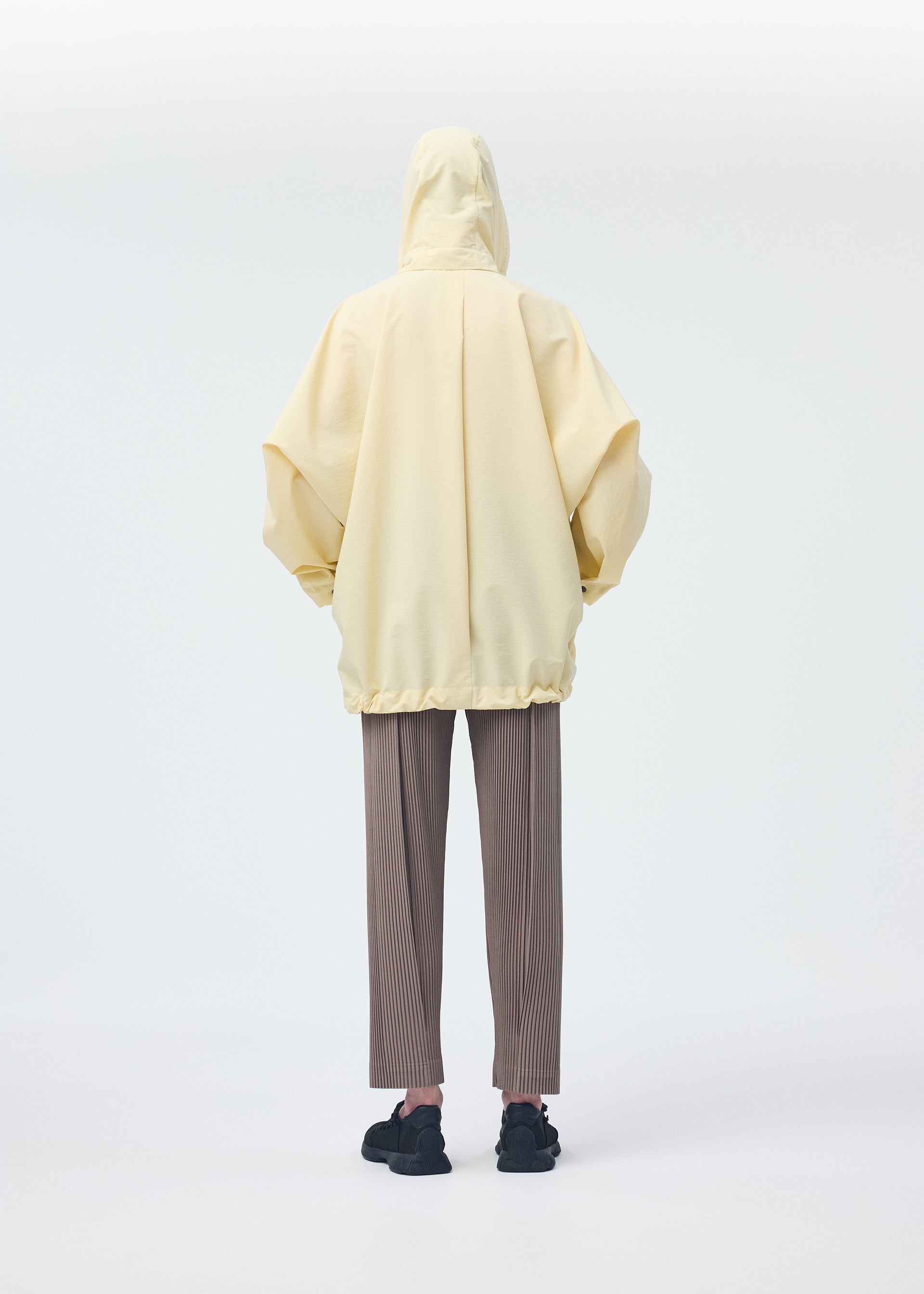 A model wears the Homme Plisse Issey Miyake PADDED RIM SHIRT shirt.