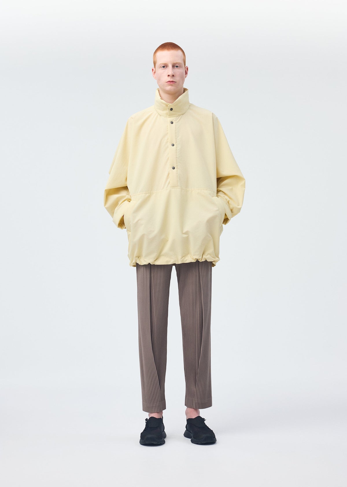 A model wears the Homme Plisse Issey Miyake PADDED RIM SHIRT shirt.