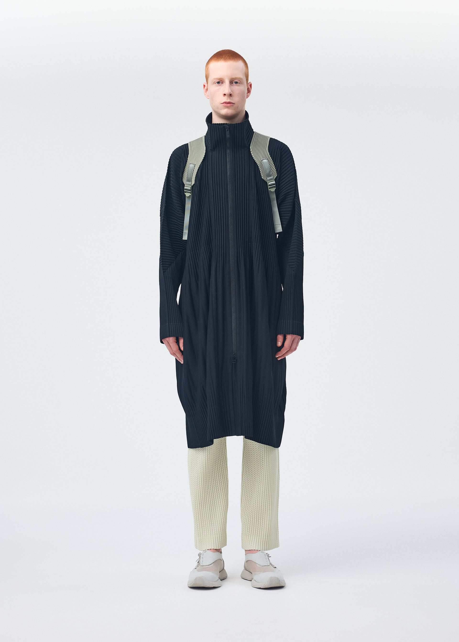 A model wears the Homme Plisse Issey Miyake MONTHLY COLORS : NOVEMBER coat.
