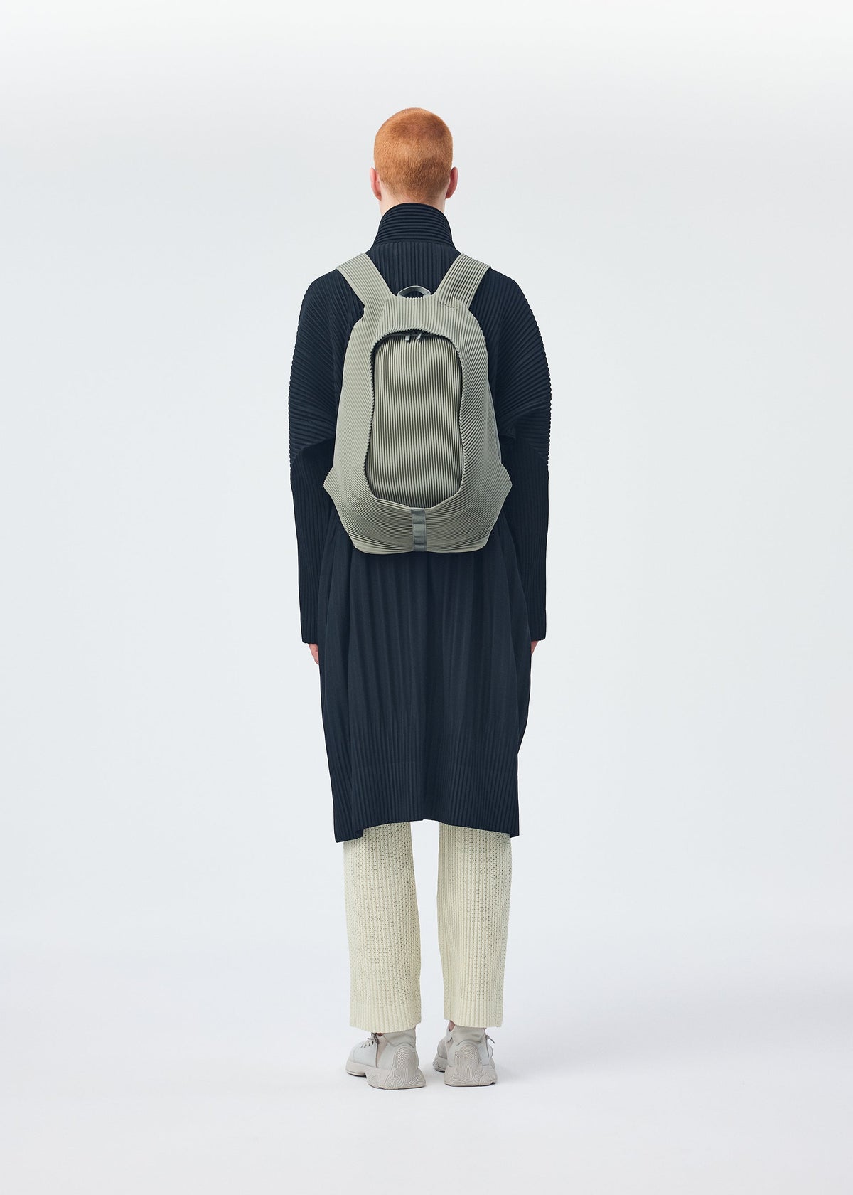 A model wears the Homme Plisse Issey Miyake MONTHLY COLORS : NOVEMBER coat.