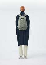 A model wears the Homme Plisse Issey Miyake MONTHLY COLORS : NOVEMBER coat.