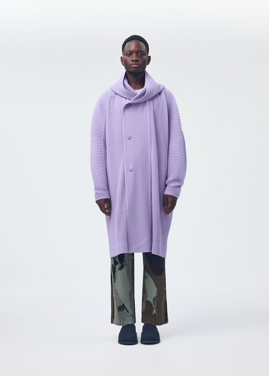 A model wears the Homme Plisse Issey Miyake MONTHLY COLORS : DECEMBER coat.