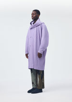 A model wears the Homme Plisse Issey Miyake MONTHLY COLORS : DECEMBER coat.