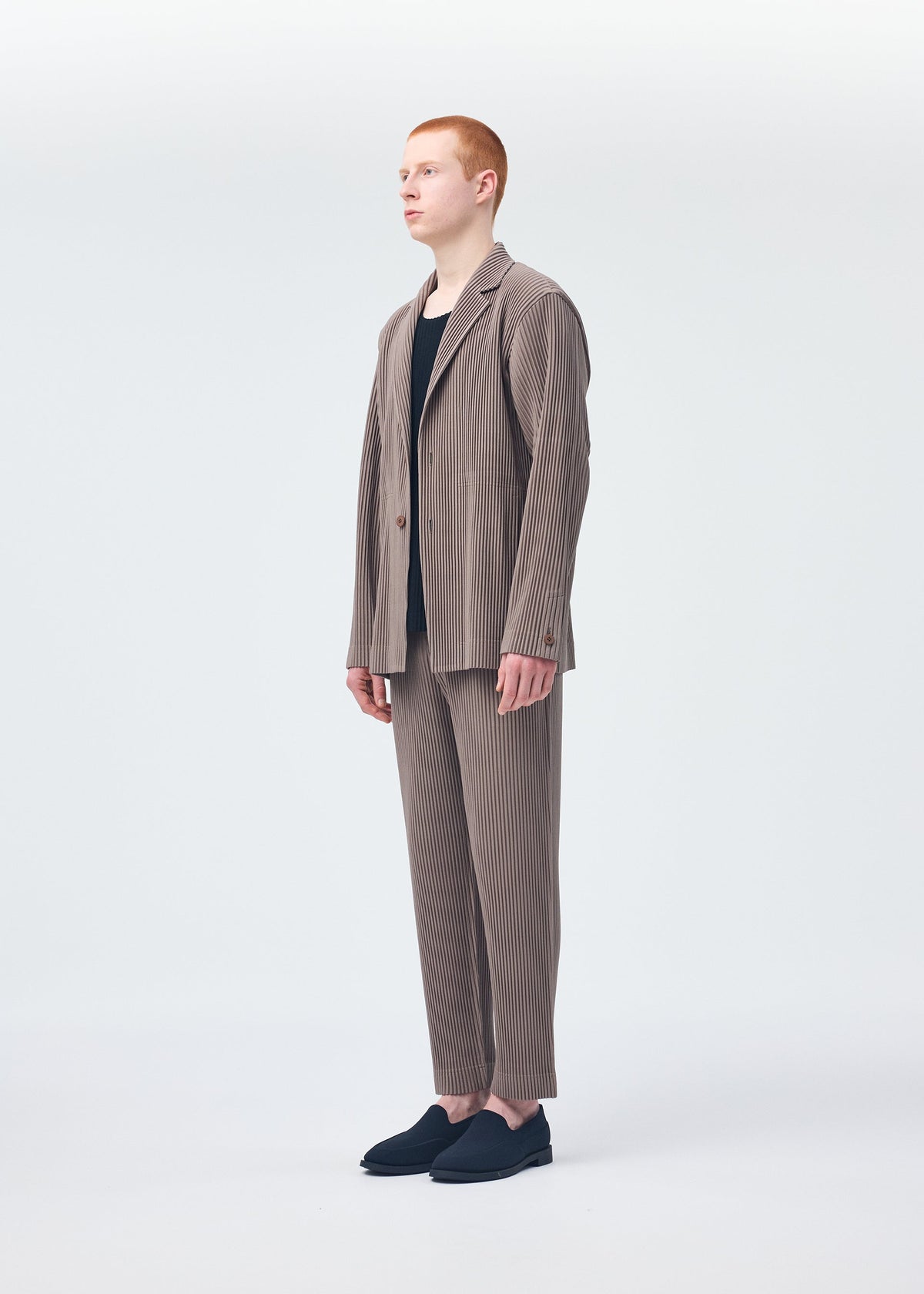 A model wears the Homme Plisse Issey Miyake TAILORED PLEATS 1 jacket.