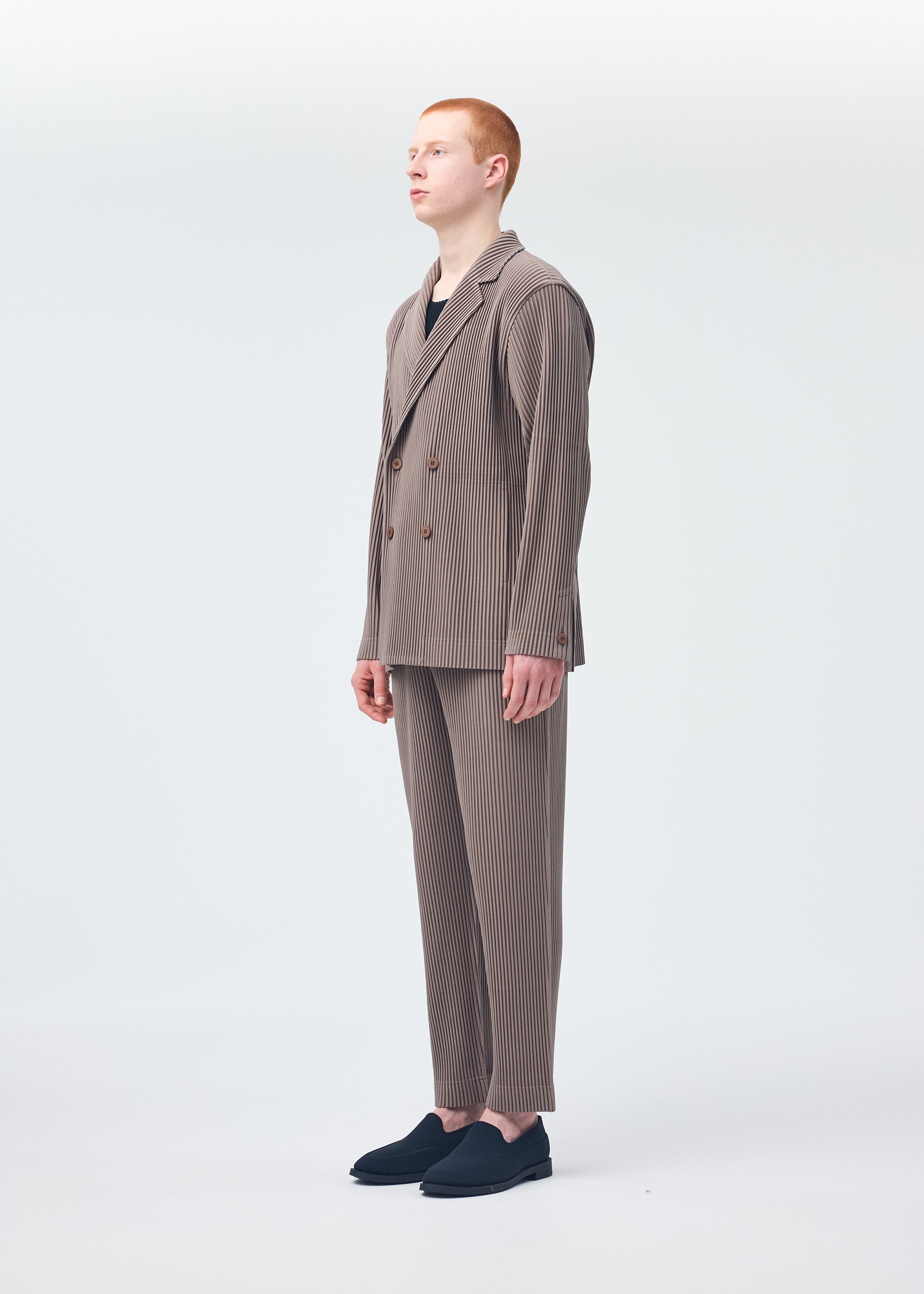 A model wears the Homme Plisse Issey Miyake TAILORED PLEATS 1 jacket.