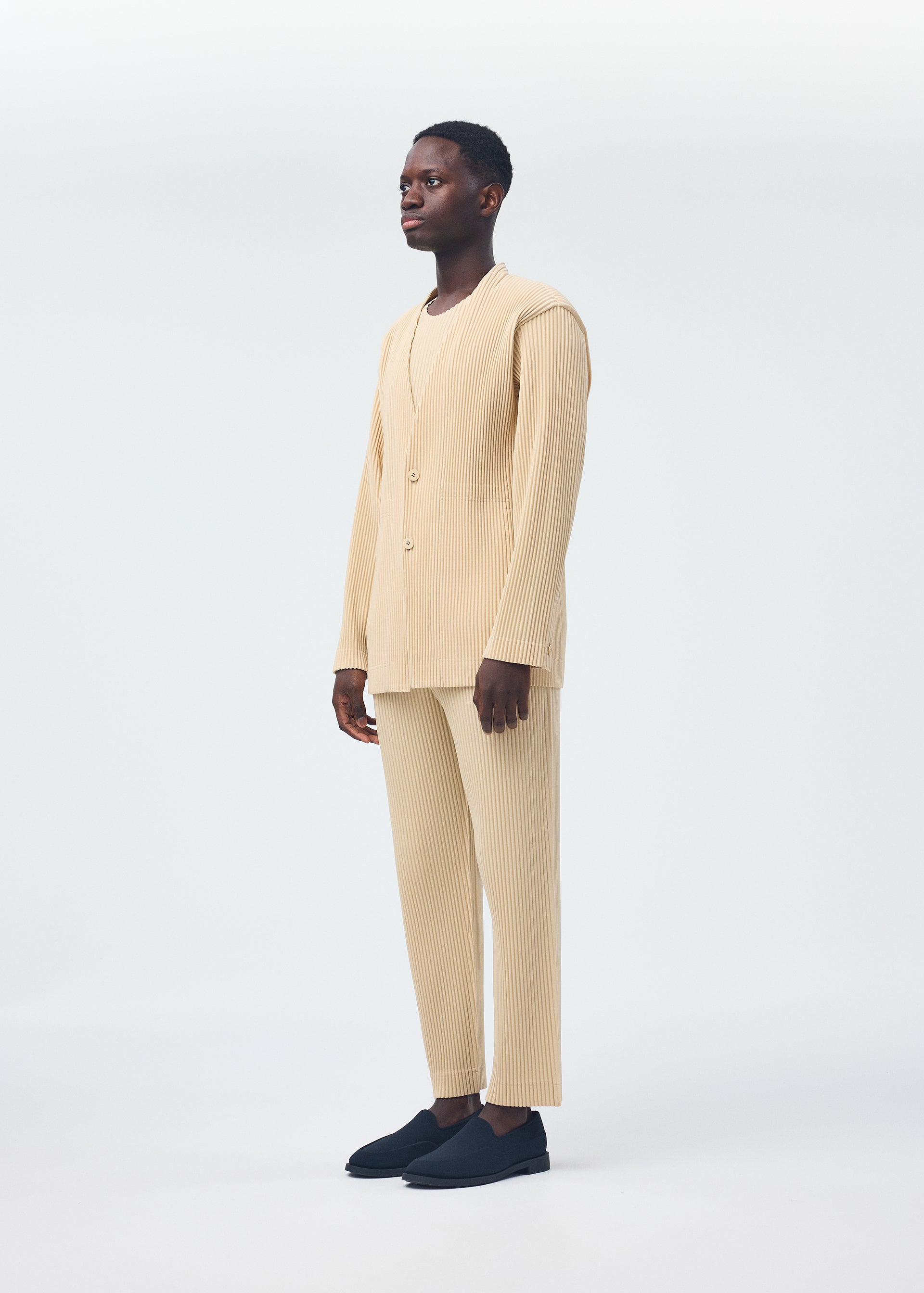 A model wears the Homme Plisse Issey Miyake TAILORED PLEATS 2 jacket.